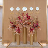 large-scale vertical floral installation beneath world clocks by al jowder flowers