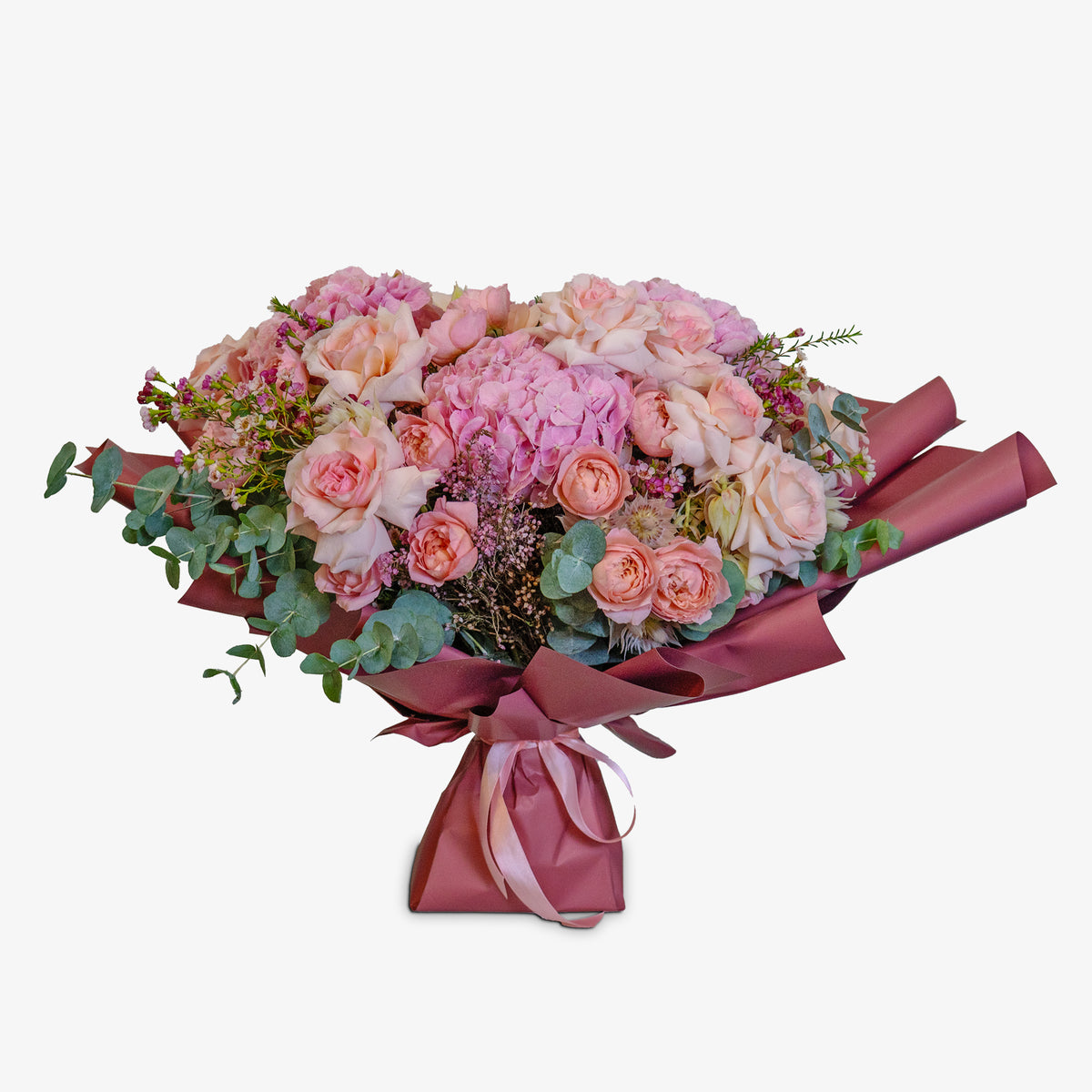 Bouquet of pink and white flowers with a red ribbon on a white background