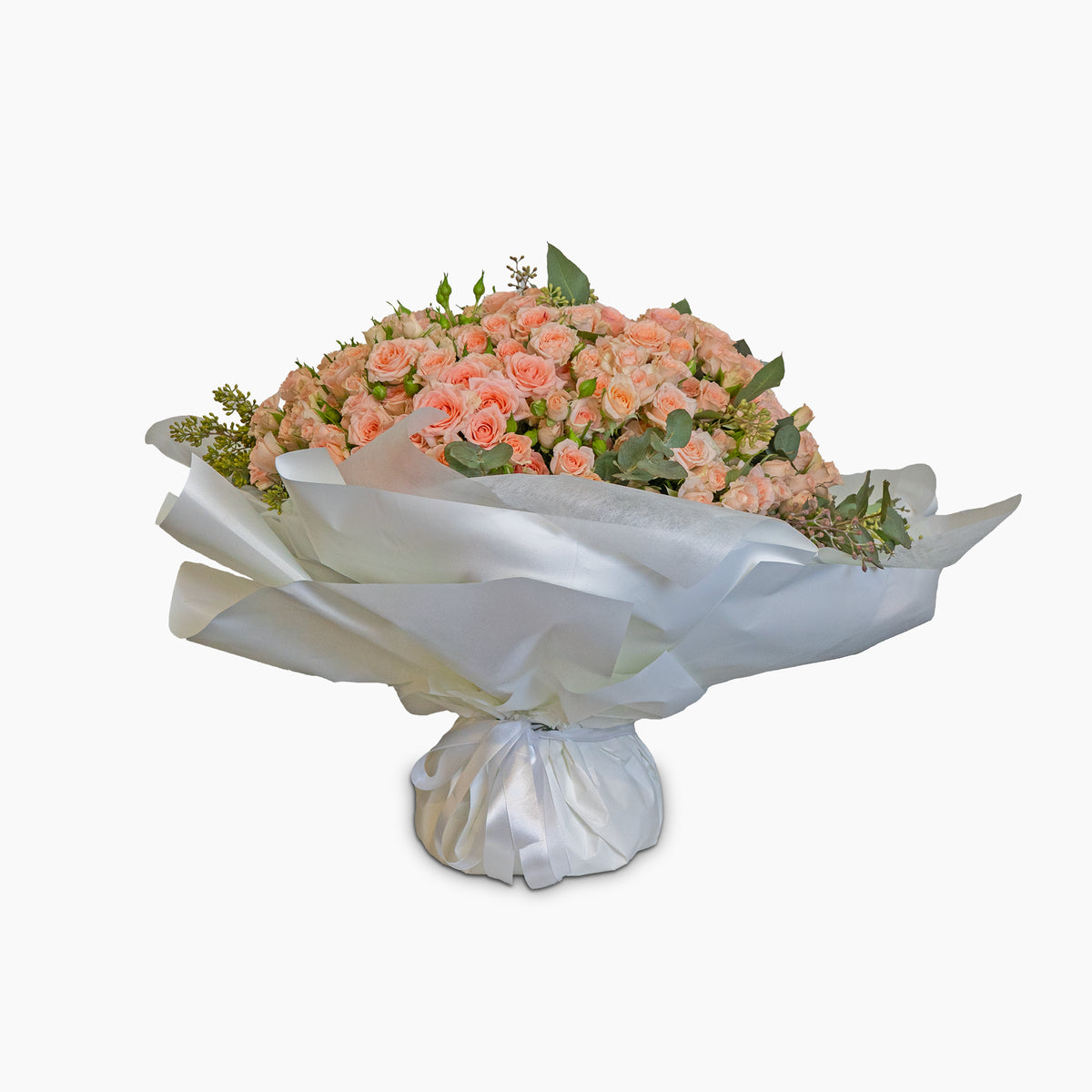 Bouquet of peach-colored flowers on a white pedestal with a white background