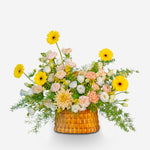 Floral arrangement in a woven basket on a white background