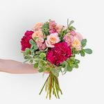Hand-tied bouquet of peach roses, deep pink hydrangeas, and soft pink stock flowers with greenery, fresh floral arrangement in Dubai & Sharjah.