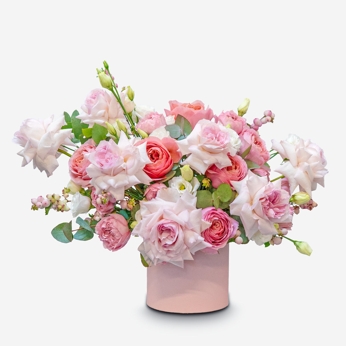 Bouquet of pink and white flowers in a pink vase on a white background