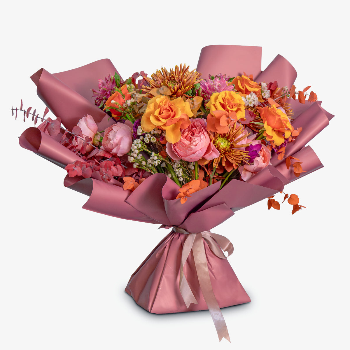 Bouquet of flowers wrapped in pink paper on a white background
