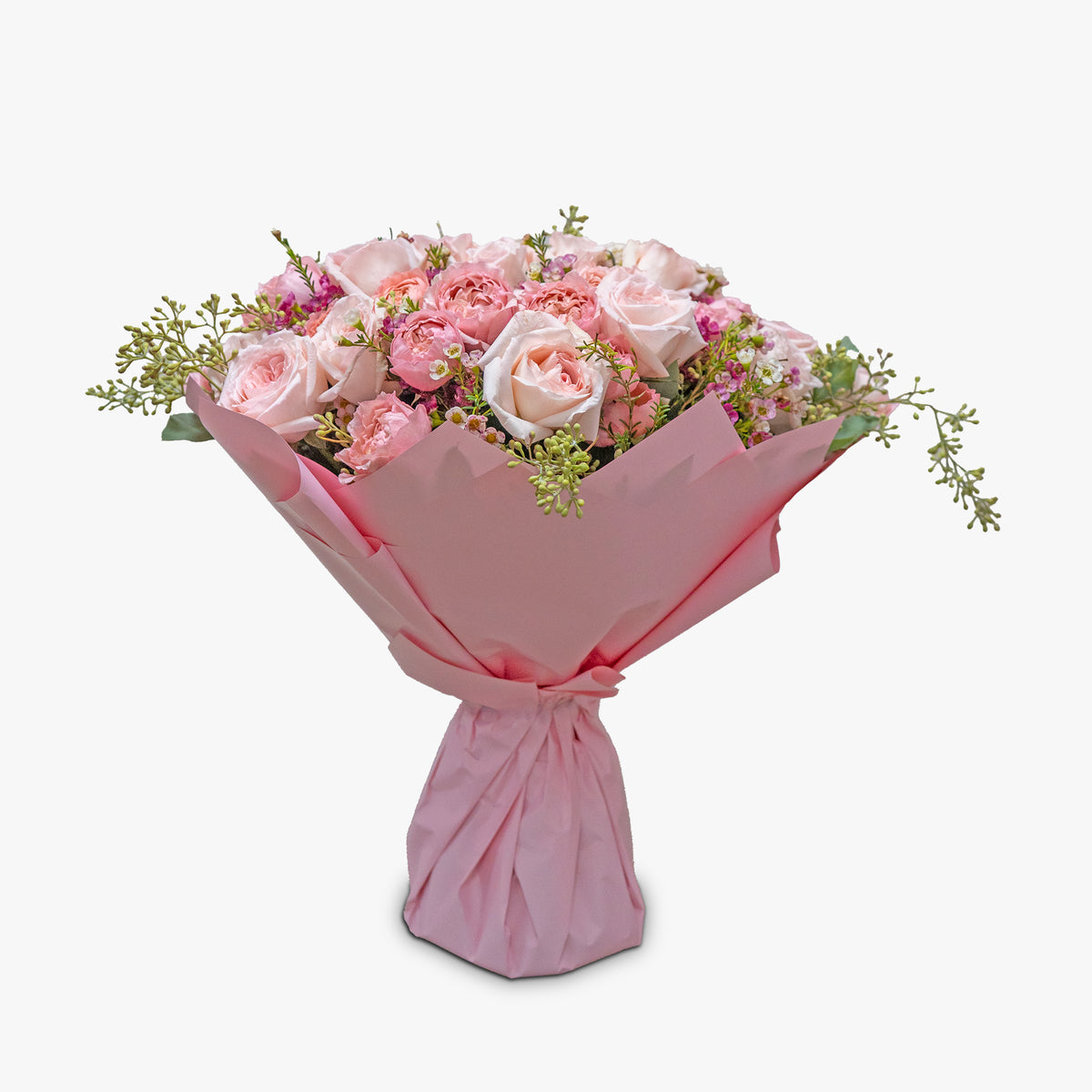 Bouquet of pink flowers wrapped in pink paper on a white background