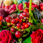 Close-up of a bouquet with red roses and berries
