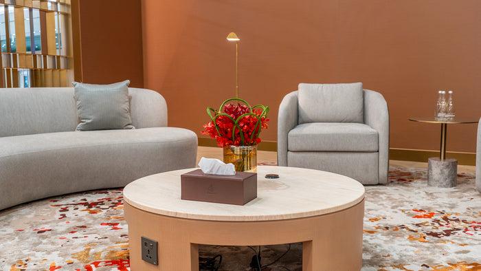 Modern living room with gray sofa, armchair, and round coffee table.