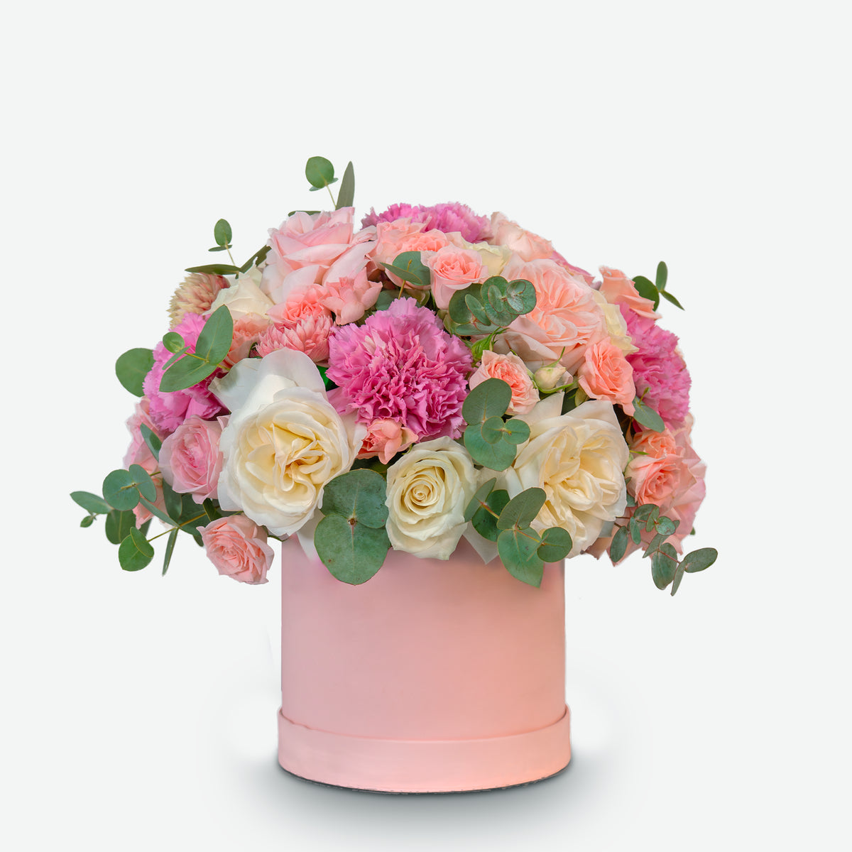 Floral arrangement in a pink box on a light gray background