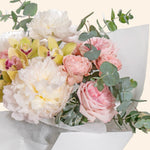 Bouquet of flowers with white, pink, and green colors on a light background