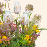 Decorative Easter eggs with rabbit designs on a floral arrangement.