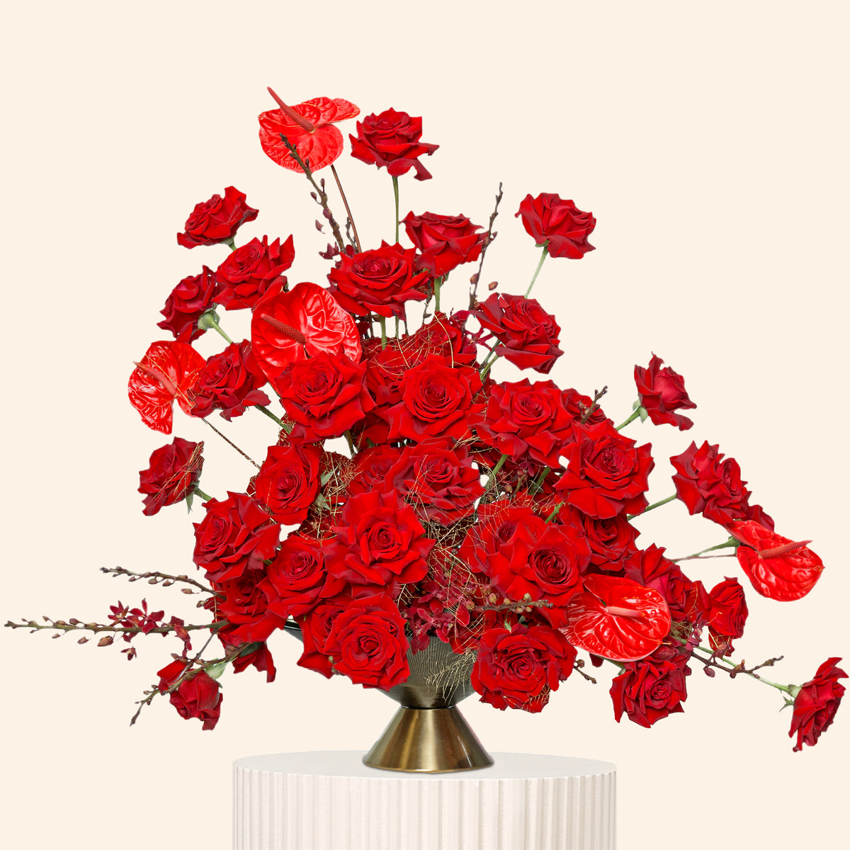 Bouquet of red roses in a vase on a pink background