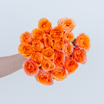 Bouquet of orange roses held by a person against a light blue background