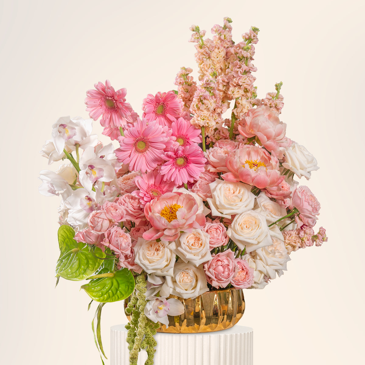 Bouquet of pink, white, and green flowers in a woven basket on a light background