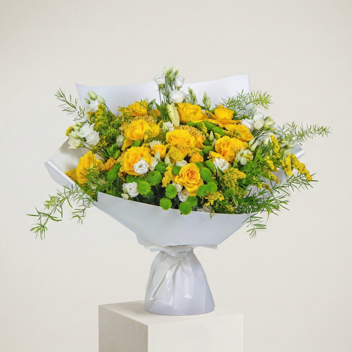 Bouquet of yellow and green flowers in a white container on a light background