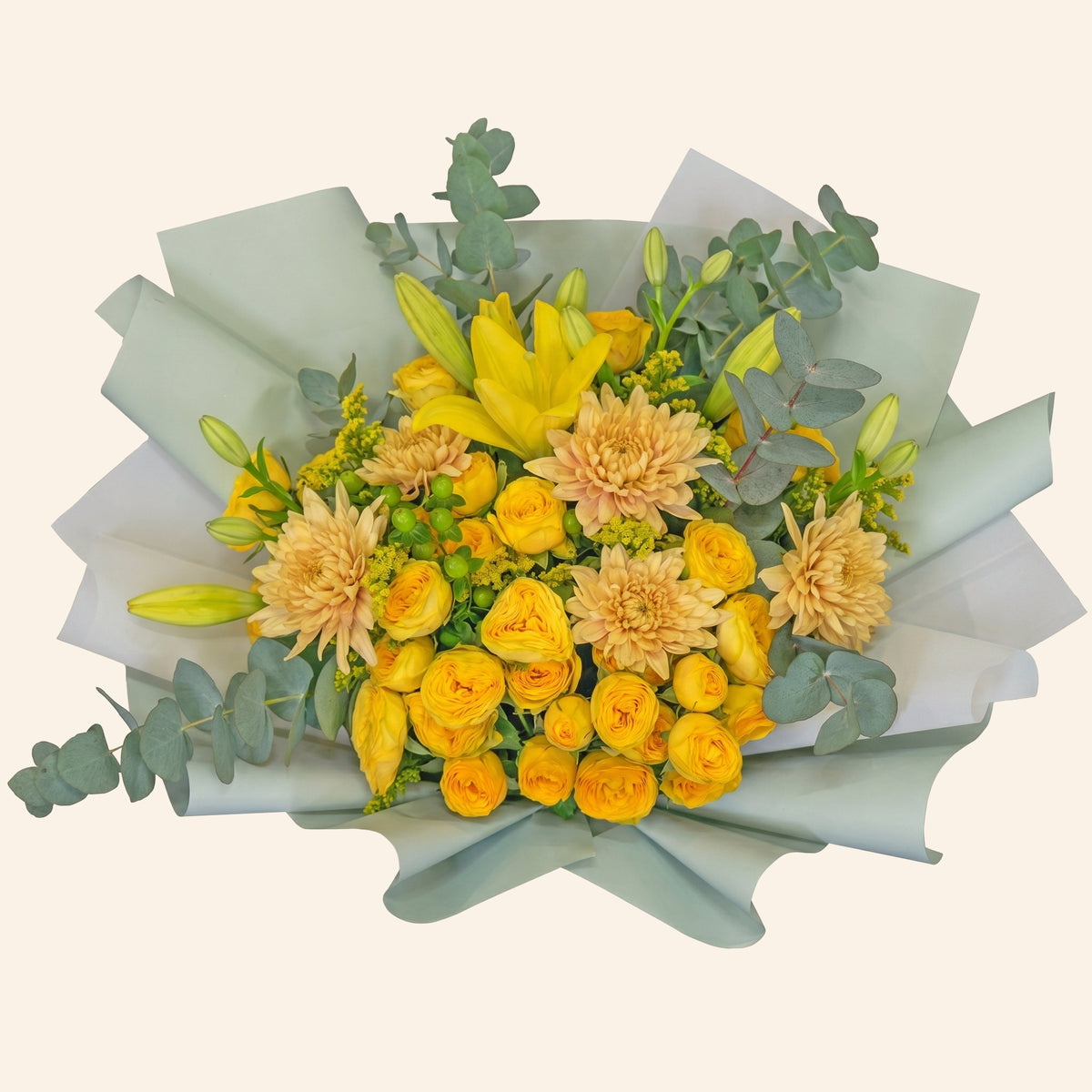 Bouquet of yellow and beige flowers with greenery on a light gray background