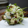 Bouquet of flowers on a white surface with a blurred background