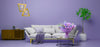 Modern living room with a purple wall, gray sofa, and decorative elements.