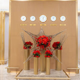 Festive star-shaped floral installation set beneath global time zone clocks in a First Class Lounge