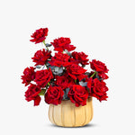 Bouquet of red roses in a wooden vase on a white background