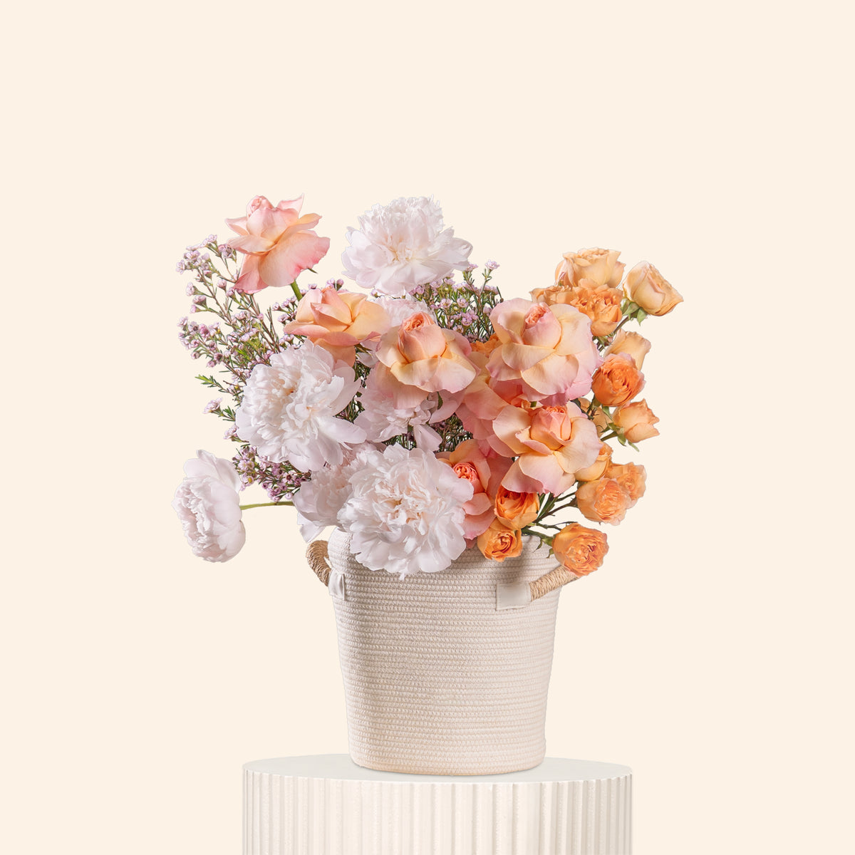Floral arrangement in a white vase on a light beige background