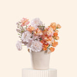Floral arrangement in a white vase on a light beige background