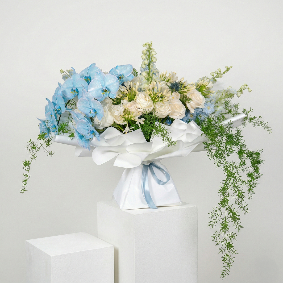 Bouquet of flowers with blue ribbons on a white background