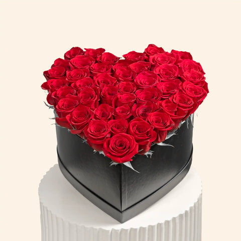 Red roses arranged in a heart shape.