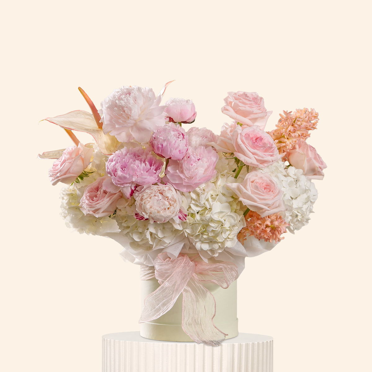 Floral arrangement with pink and white flowers in a vase on a light background