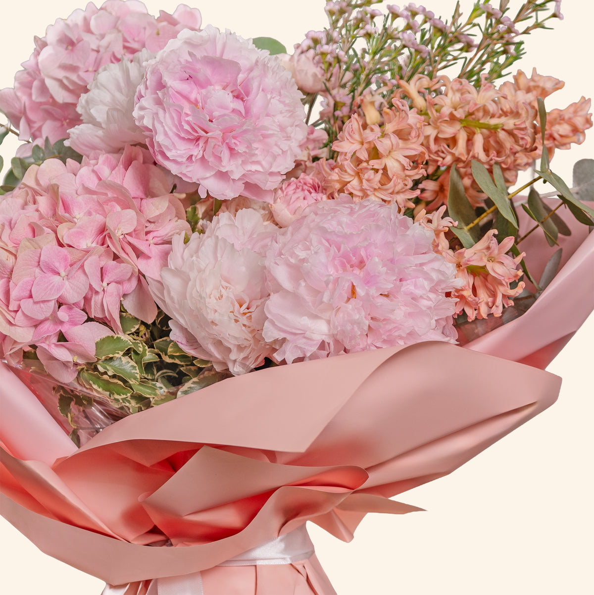 Bouquet of pink flowers with a pink ribbon on a light background