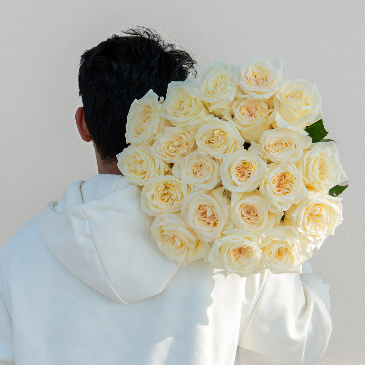 A warm-toned arrangement of cream and pink roses