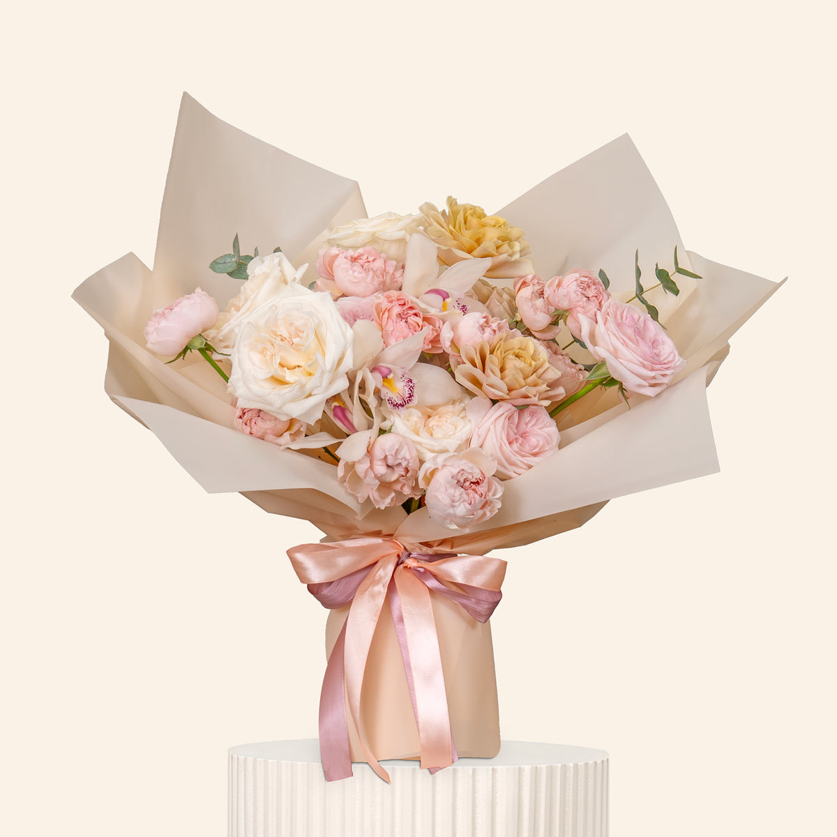 Bouquet of pink and white flowers with a pink ribbon on a light beige background