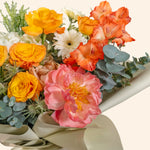 Bouquet of yellow and white roses with greenery
