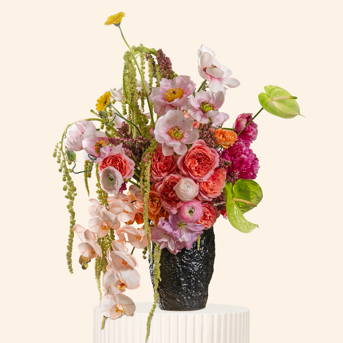 Bouquet of flowers in a black vase on a white background