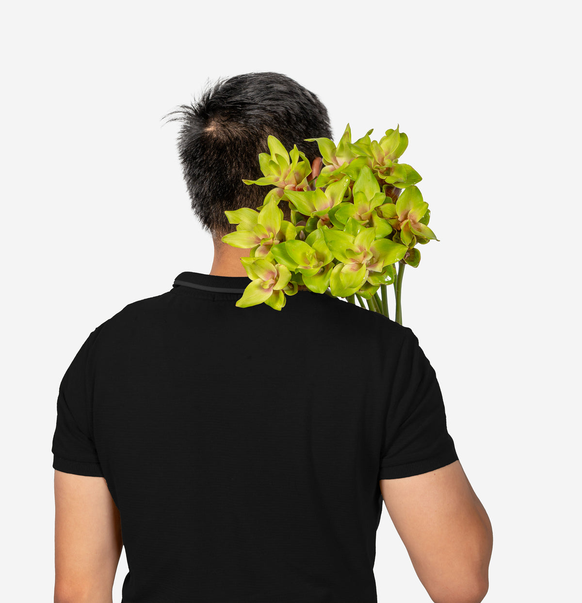 Person wearing a black shirt with a bouquet of green flowers held behind their back on a white background
