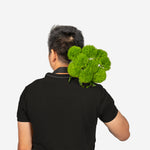 Person wearing a black shirt with green decorative elements on a white background