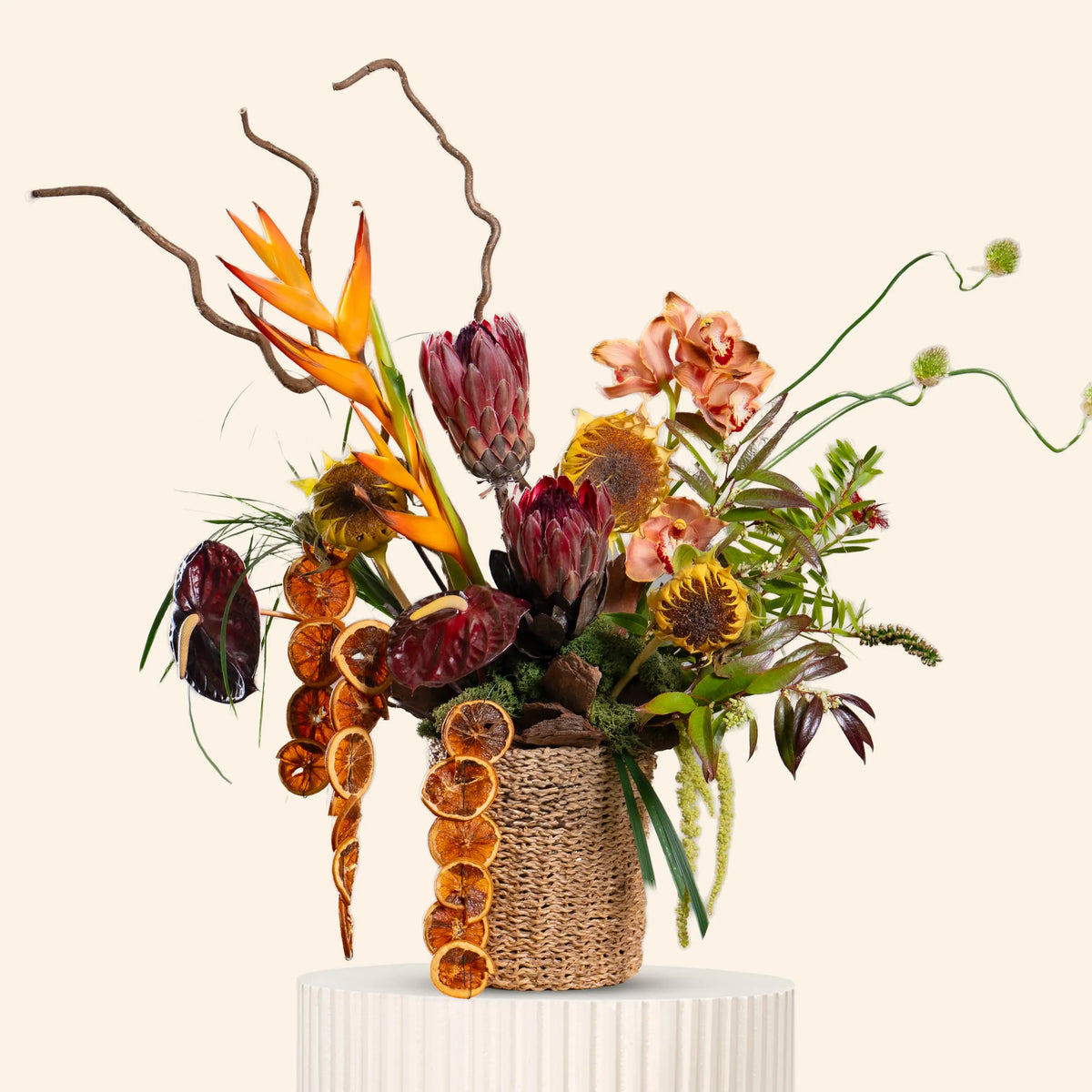 Decorative floral arrangement with dried elements on a beige background