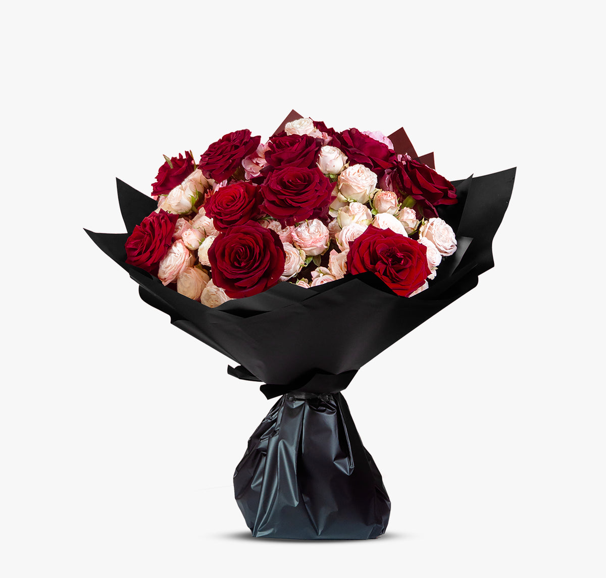 Bouquet of red and pink roses wrapped in black paper on a white background