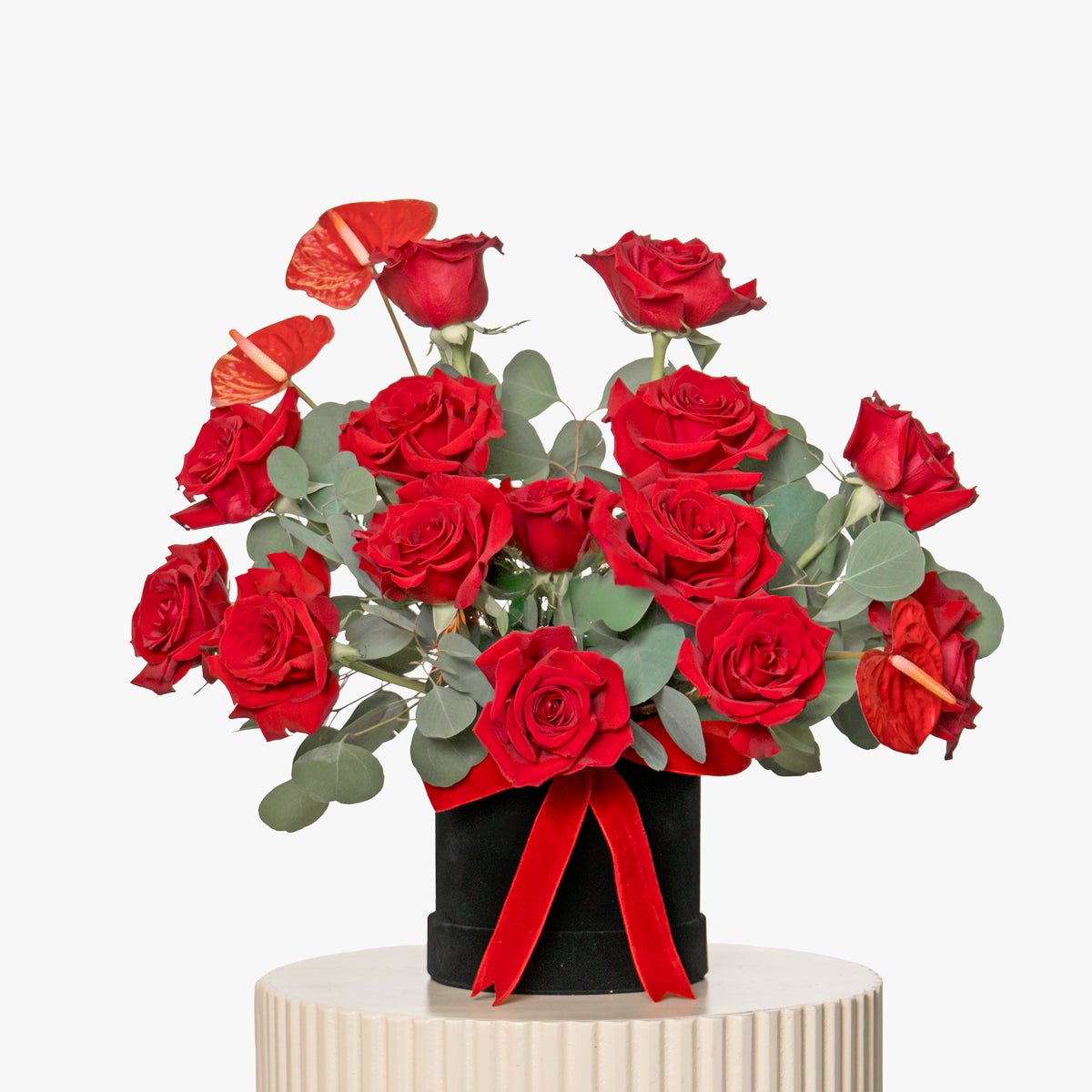 Bouquet of red roses with a red ribbon on a white background