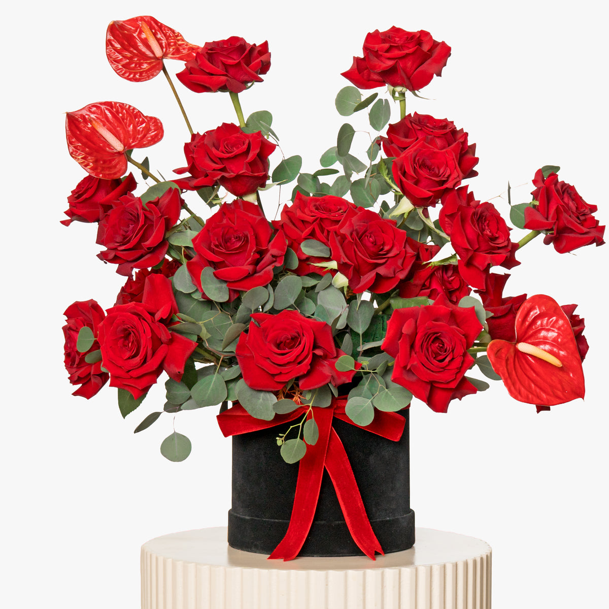 Bouquet of red roses with a black vase on a white background