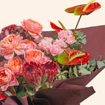 Bouquet of flowers with pink and red flowers on a white background