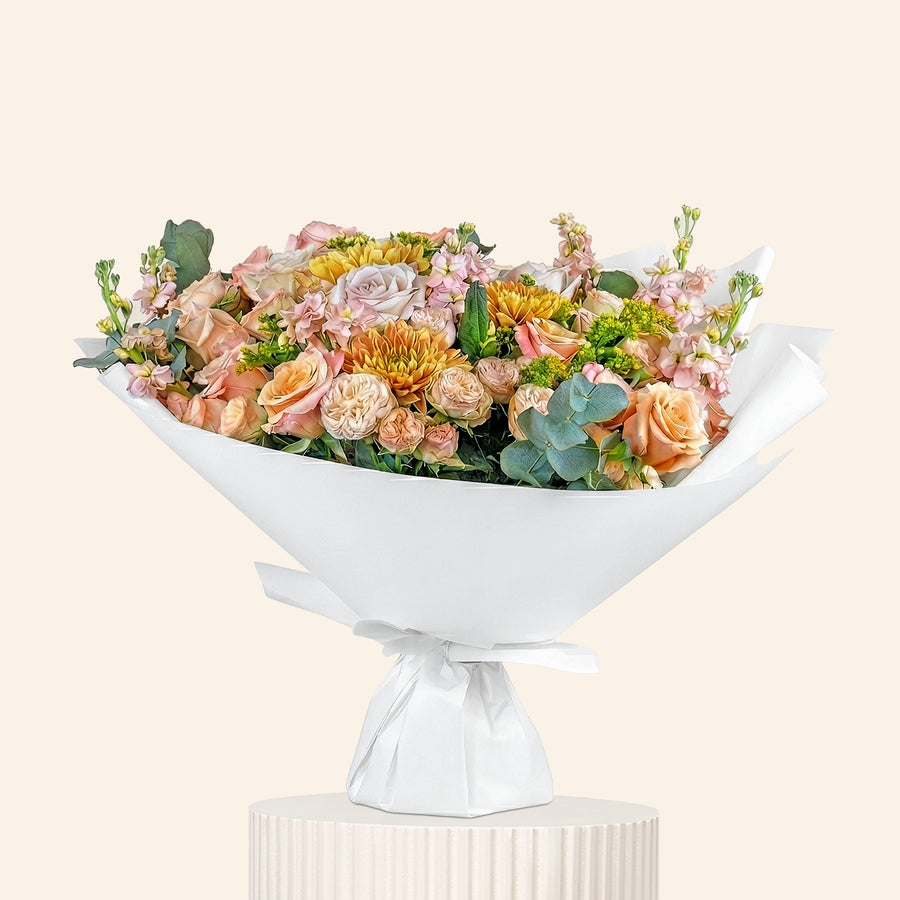 Floral arrangement in a white decorative bowl on a light beige background
